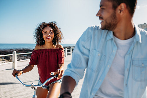 Tourist couple riding on bicycles in the city