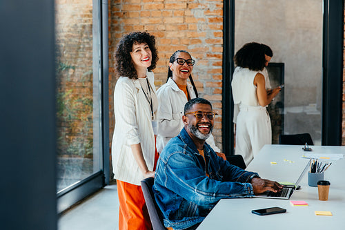 Joyful collaboration: A multiethnic corporate team in a modern office space