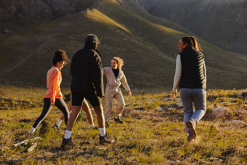 Group hiking together in scenic hills