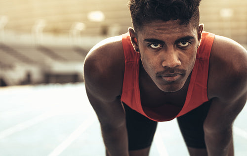 Close up of a runner standing on a running track