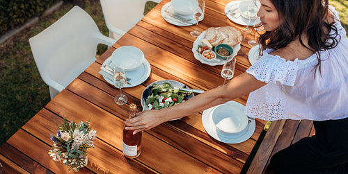 Woman setting a dining table for housewarming