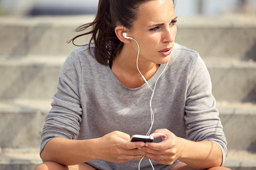 Female Athlete Listening to MP3 Music