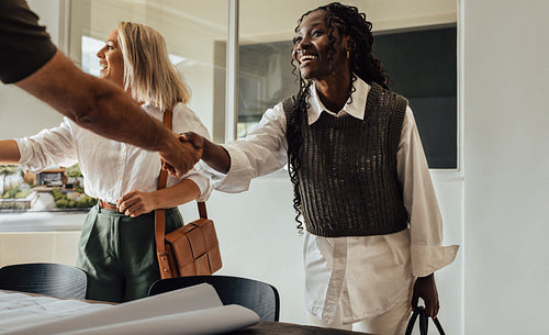 Business team handshake at an architecture firm's project discussion meeting