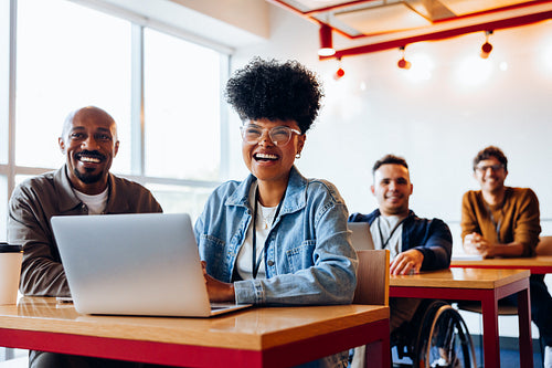 Whole team engaged: Diverse coworkers collaborating in a modern office