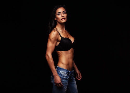 Young woman posing in sexy bra and jeans