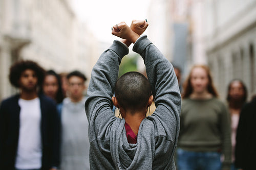 Female protesting with rebellions outdoors on road