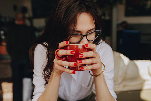 Woman sitting at cafe with a cup of coffee