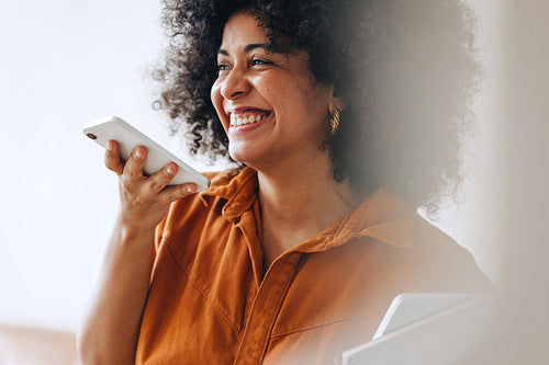 Black businesswoman smiling cheerfully on a phone call