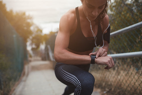 Woman setting up the smartwatch for the stairs climbing
