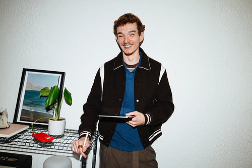 A tablet scene with a young man using mobile apps indoors.