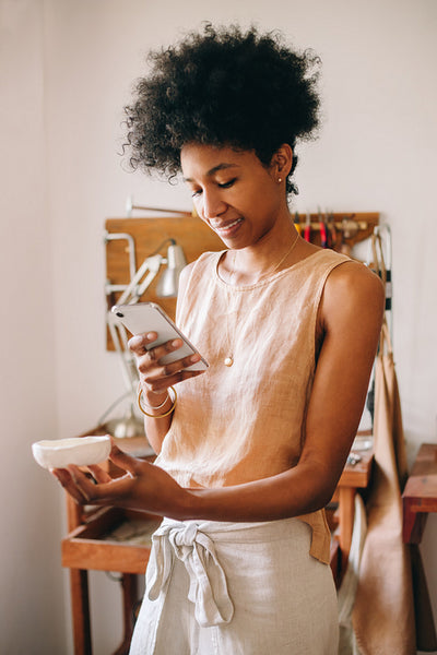 Jewelry designer photographing product