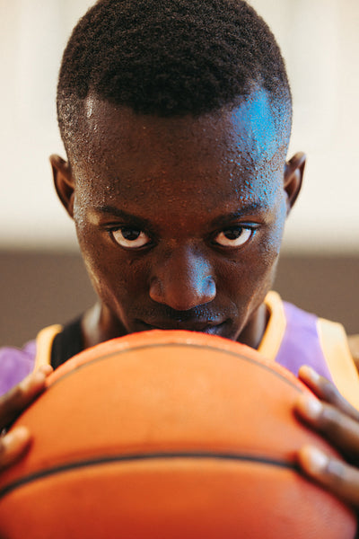 Basketball player holding a ball with intense focus and determination