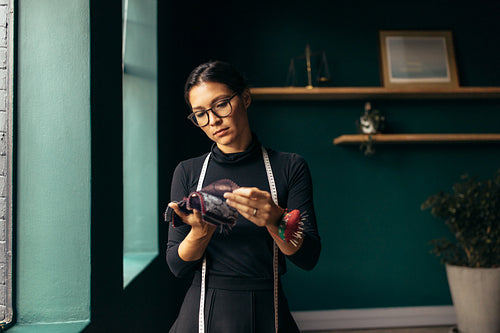 Woman tailor choosing the best fabric