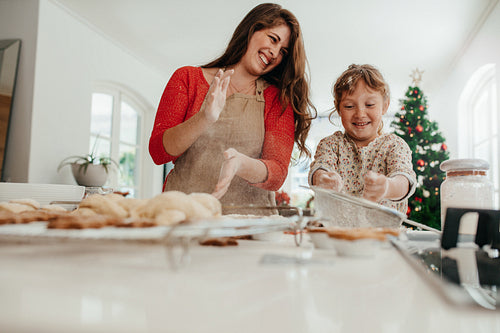 Mother and daughter having fun while making Christmas cookies.