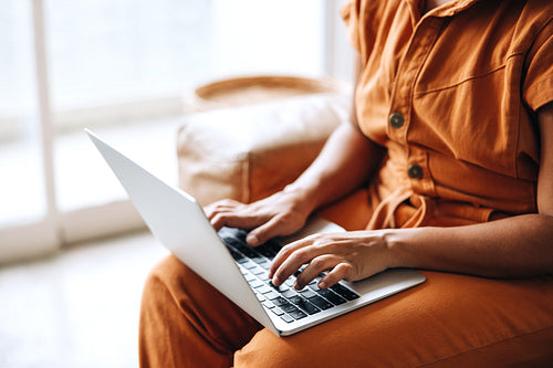 Unrecognizable businesswoman using a laptop in an office