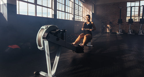 Young woman exercising in gym