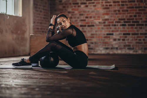 Woman relaxing after intense workout at gym