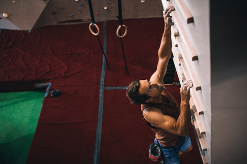 Man training on a campus board