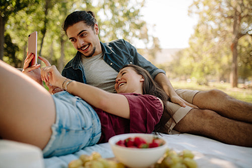 Couple social networking on picnic