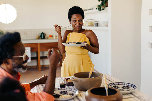 Black Brazilian family enjoying a home-cooked meal together in the kitchen