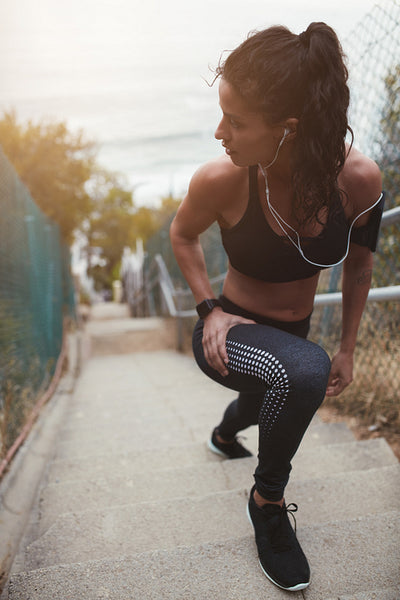Fitness young woman stretching outdoors