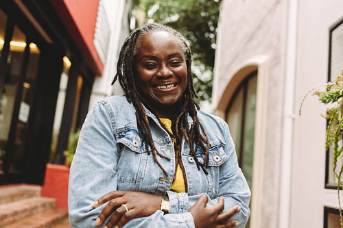 Black woman with dreadlocks smiling at the camera