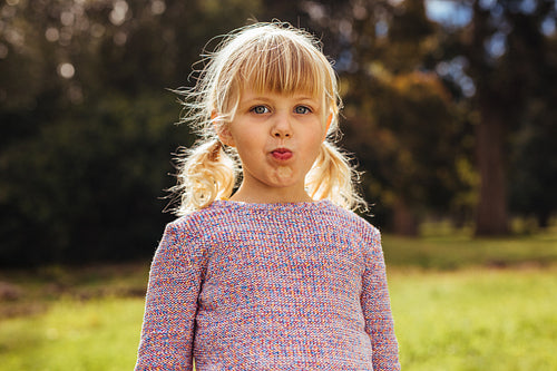 Beautiful little girl standing at park
