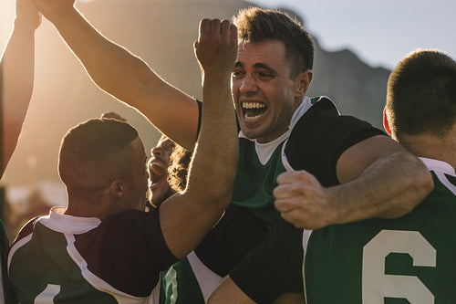 Rugby team cheering and celebrating victory