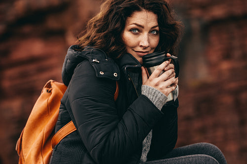 Female hiker resting with a coffee