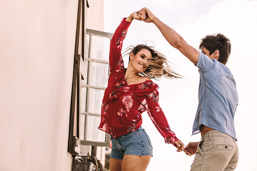 Happy couple dancing holding hands