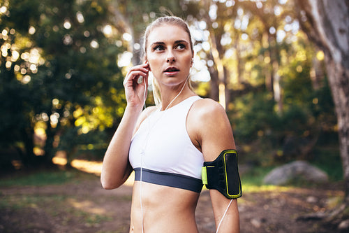Female runner wearing earphones during workout