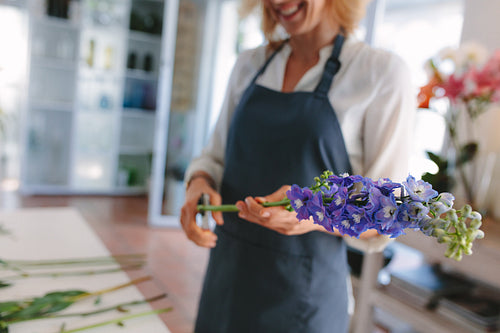 Female florist creating bouquet of flowers