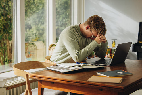 Man feeling disappointed while working on laptop