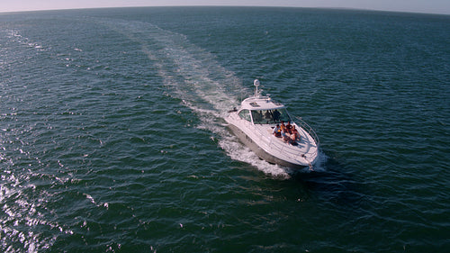 Young people relaxing on deck of yacht