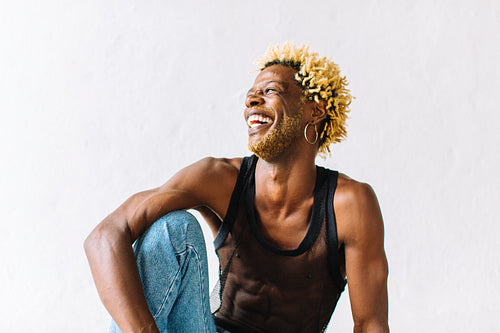 Smiling nonconforming man in a studio