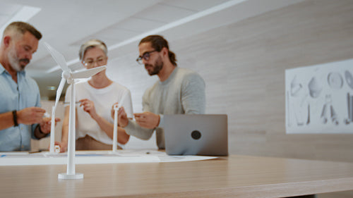 Group of innovative engineers brainstorming wind energy solutions in a collaboration
