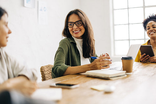 Group of happy business women having a meeting in a boardroom