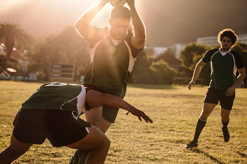 Rugby players fighting for ball