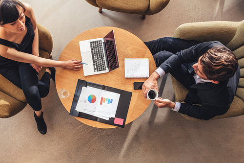 businesswoman meeting with businessman at office lobby