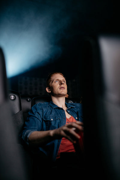 Young man watching movie in theater