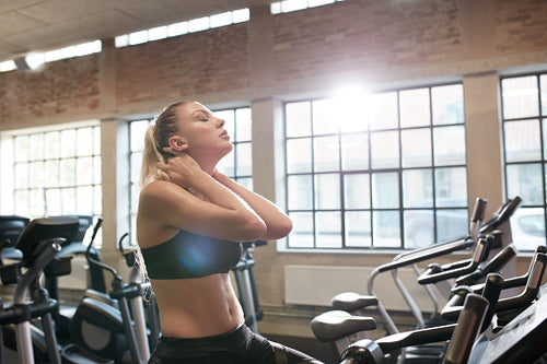 Woman tired after intense workout on gym bike