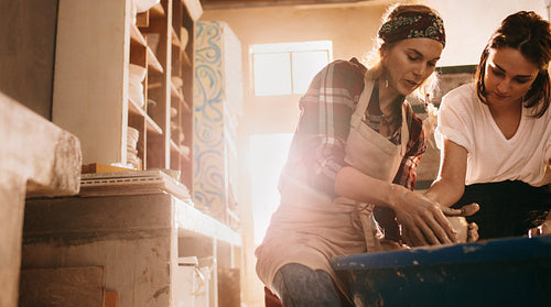 Woman teaching the art of pot making