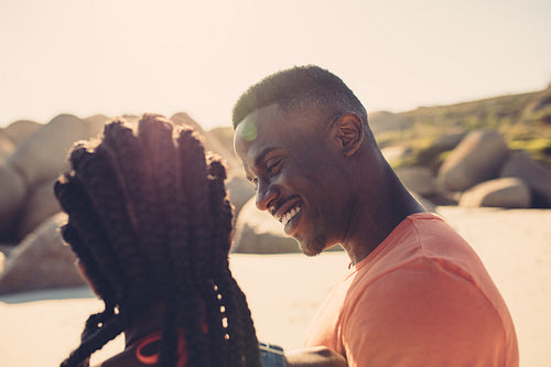 African couple along the seashore on a summer day