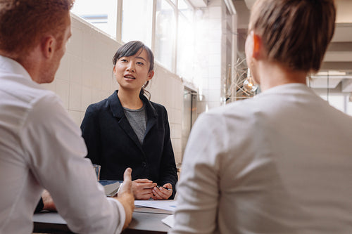 Businesswoman explaining new business ideas to colleagues.