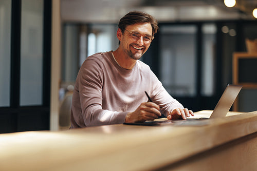 Graphic design professional working in a cafe