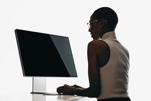 Professional woman working at a computer in a modern office setting
