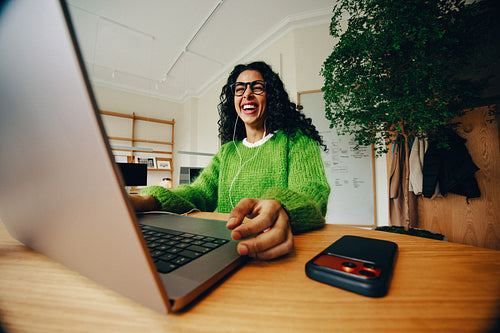 The business woman brings a smiling focus to laptop work in the office