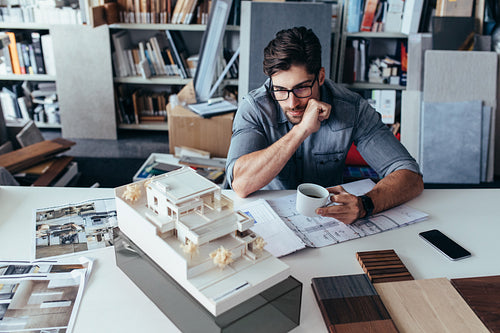 Young male architect taking break from work