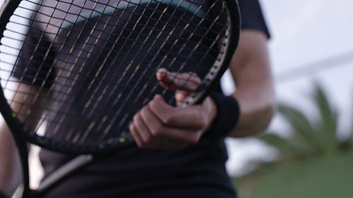 Tennis player with a racket on the hard court