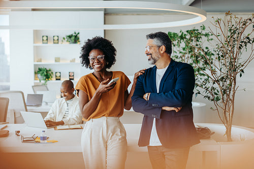Diverse team of professionals smiling in open-plan office